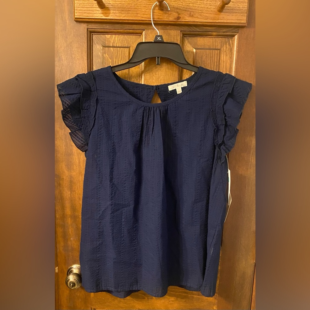Navy flutter sleeve top with open back.